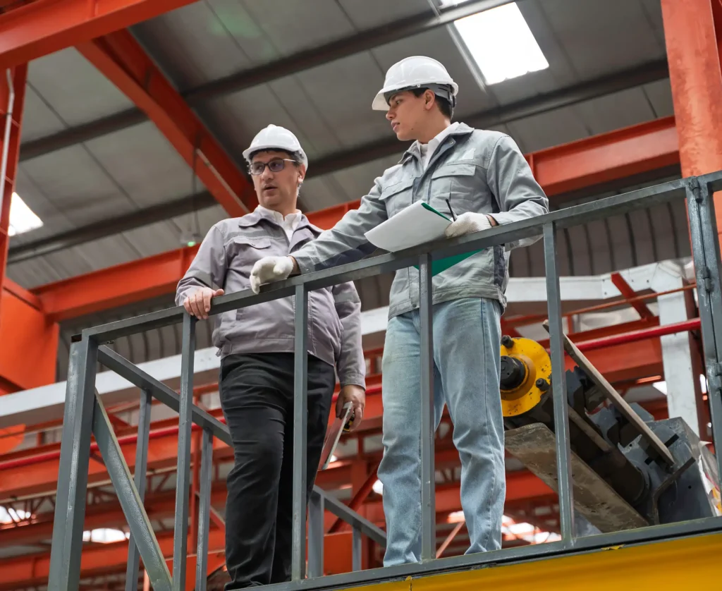 discussing maintenance procedures inside a modern industrial factory
